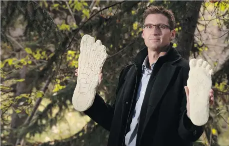  ?? Gavin Young/Calgary Herald ?? Calgarian Tyler Huggins holds plaster casts from what are believed by some to be “Bigfoot” prints. Huggins believes he and his friends saw one of the mysterious creatures while hiking in the Rockies in the 1990s.