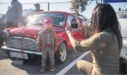  ?? Picture: Yeshiel Panchia ?? Uzae Chellan poses for a photo in front of one of the cars at the Forest Hill Youth Day Motor Show in Joburg yesterday.