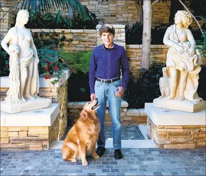  ?? Gary Coronado Los Angeles Times ?? DEAN KOONTZ with his dog Elsa at home in Newport Beach. He’s written more than 100 books, 14 of which were No. 1 print bestseller­s. But his latest “Nameless” series is available only in electronic and audio forms. His computer has no internet access.