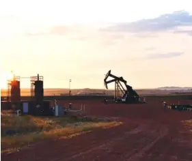  ?? AP FILE PHOTO/MATTHEW BROWN ?? A working oil well is shown at sunrise in Watford City, N.D. The Biden administra­tion on Friday called for an overhaul of the nation’s oil and gas leasing program to focus on areas that are most suitable for energy developmen­t and raise costs for energy companies to drill on public lands and water.