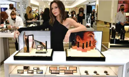  ?? ?? Victoria Beckham poses with a display of Victoria Beckham Beauty products at Bergdorf Goodman in New York. Photograph: Craig Barritt/Getty Images for Bergdorf Goodman