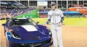  ?? MIKE EHRMANN/GETTY IMAGES ?? Robinson Cano poses with his Chevrolet Corvette he chose as his prize for winning the MVP award Tuesday night.