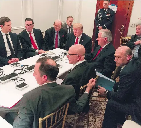  ??  ?? An image released by White House on Friday shows President Donald Trump receiving a briefing on the Syria strike Thursday from the National Security team, including Secretary of State Rex Tillerson, via secure video teleconfer­ence.