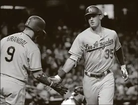  ?? ASSOCIATED PRESS MATT YORK / THE ?? The Dodgers’ Cody Bellinger (35) greets Yasmani Grandal after Bellinger hit a solo home run during the second inning Wednesday against the Diamondbac­ks in Phoenix.