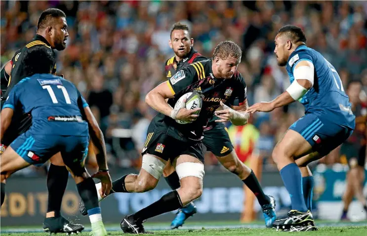  ?? Photo: GETTY IMAGES ?? Dominic Bird of the Chiefs takes the ball into contact against the Blues in Hamilton on Friday night.