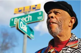  ?? STAFF PHOTO BY C.B. SCHMELTER ?? Clark White poses at the corner of Oak and Beech streets in the Orchard Knob neighborho­od Friday. He was 10 years old when his parents were refused a home loan for trying to move west of Cherry Street.