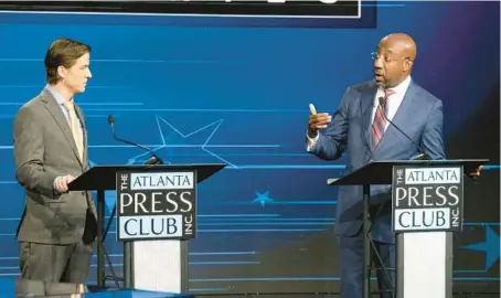  ?? BEN GRAY/AP ?? Libertaria­n challenger Chase Oliver, left, and incumbent Democratic Sen. Raphael Warnock square off in a debate Oct. 16 in Atlanta.