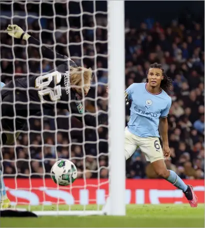  ?? ?? Nathan Ake provided the winning goal, above, after Riyad Mahrez had scored to put City 2- 1 ahead, below