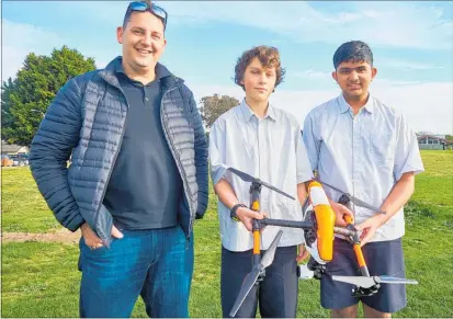  ??  ?? Drone instructor Ryan Groves with Paraparaum­u College students Niraj Gandhi and Luke Bayne.