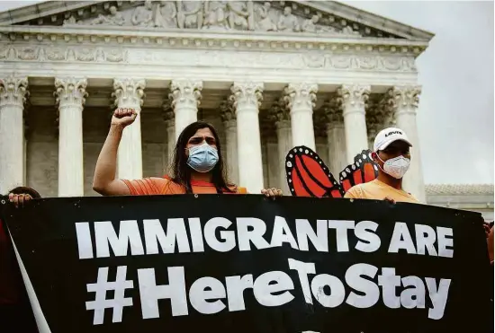  ?? Drew Angerer - 18.jun.20/Getty Images/AFP ?? Manifestan­tes protestam a favor de imigrantes em frente à Suprema Corte dos EUA, no dia em que tribunal vetou o fim do Daca