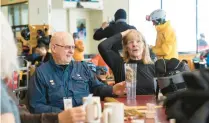  ?? ?? Wild old Bunch members Dave Wahlstrom and Anne Kronawitte­r join others in the group March 13 at Alf’s Restaurant after morning runs.