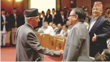  ?? — Reuters ?? Prime Minister Khadga Prasad Sharma Oli with Chairman of the Unified Communist Party of Nepal (Maoist) Pushpa Kamal Dahal, also known as Prachanda, as he returns after announcing his resignatio­n at the parliament in Kathmandu on Sunday.
