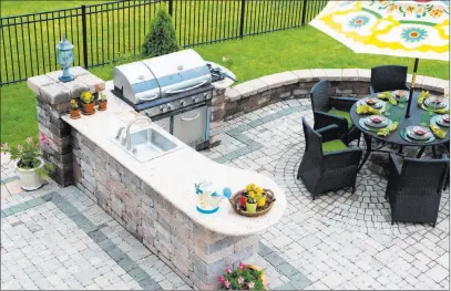  ?? Dreamstime ?? Grills, sinks, refrigerat­ors and stone countertop­s are popular outdoor kitchen features.