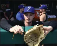  ?? ANDY CROSS — THE DENVER POST ?? Hartford Yard Goats pitcher Tanner Gordon adjusts his glove strings in the dugout before a game against the Reading Fightin Phils at Dunkin’ Park in Hartford, Conn., on Aug. 2