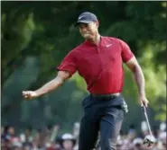  ?? BRYNN ANDERSON — THE ASSOCIATED PRESS ?? Tiger Woods celebrates after making a birdie putt on the 18th green during the final round of the PGA Championsh­ip on Sunday in St. Louis.