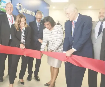  ??  ?? Minister of Public Telecommun­ications, Catherine Hughes (third from right) cutting the ribbon to the second building at the Qualfon Providence Campus yesterday, along with President of Qualfon Guyana, Christina Morris (second from left) and Vice...