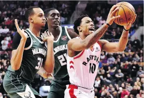  ?? FRANK GUNN / THE CANADIAN PRESS ?? DeMar DeRozan drives to the basket during Toronto’s 131-127 OT win over the Milwaukee Bucks at the ACC on Monday.