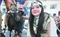  ?? CLODAGH KILCOYNE / REUTERS ?? Puck Queen Caitlin Horgan, 12, poses with the newly crowned King Puck goat in Killorglin, Ireland, on Thursday.