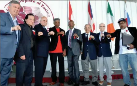  ?? JOHN BREWER - ONEIDA DAILY DISPATCH ?? From left to right, Internatio­nal Boxing Hall of Fame Class of 2019induct­ees : Teddy Atlas, Don Elbaum, Lee Samuels, Julian Jackson, Donald Curry, Tony DeMarco, Guy Jutras and Buddy McGirt display their IBHOF rings during the induction ceremony Sunday, June 9, 2019, in Canastota, N.Y.