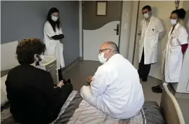  ?? THIBAULT CAMUS AP ?? Psychiatri­st Olivier Guillin, center, talks with a 22-year-old student at the Rouvray psychiatri­c hospital in Rouen, France, on Nov. 25.