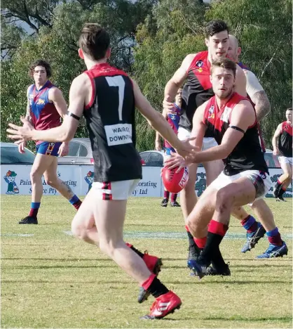  ??  ?? Warragul captain Brayden Fowler receives some support from team mates Angus Emery (7) and Dylan Proctor as he looks to send his side into attack. Fowler kicked three goals in the loss to Moe on Saturday.