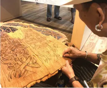  ??  ?? Social entreprene­ur Mathew Ngau Jau painting traditiona­l Kenyah motifs on canvas made of tree bark recently.