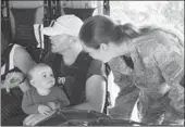  ?? SERGEANT SAM SHEPHERD VIA REUTERS ?? A Royal New Zealand Air Force member helps evacuate a toddler and others aboard a helicopter from Kaikoura on Tuesday.