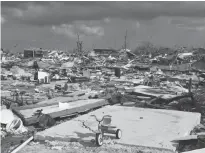  ?? REUTERS ?? A child’s bicycle is seen in a destroyed neighborho­od in the wake of Hurricane Dorian in Marsh Harbour, Great Abaco, Bahamas.