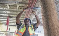  ?? BRAD VEST/THE COMMERCIAL APPEAL ?? Renovation of Peabody Place for ServiceMas­ter is ramping up. Estimates say contractor­s will employ about 800 constructi­on workers, including about 390 women and minorities.