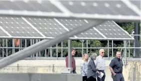  ?? Elise Amendola, The Associated Press ?? Former vice president and Democratic presidenti­al candidate Joe Biden, second from right, looks at an array of solar panels during a June 4 tour at the Plymouth Area Renewable Energy Initiative in Plymouth, N.H.