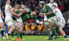  ?? Photograph: Tim Williams/Action Plus/Shuttersto­ck ?? Franco Mostert is tackled by Tom Curry during South Africa’s dominant display against England.