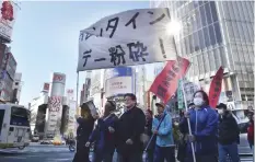  ?? — AFP ?? A group of Japanese protesters stage an anti-Valentine’s Day demonstrat­ion march in Tokyo.