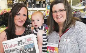  ??  ?? Winner Lee-Anne Rielly is pictured being presented with her prize at Tesco’s store