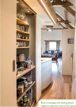  ??  ?? Built-in storage with sliding doors helps to make the most of the space