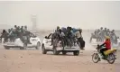  ?? AFP/Getty Images ?? sit on the back of pickup trucks, as they leave the outskirts of Agadez, Niger, for Libya in 2015. Photograph: Issouf Sanogo/