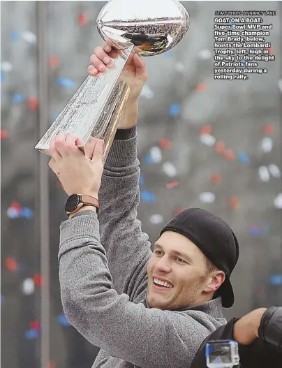  ??  ?? STAFF PHOTO BY NANCY LANE GOAT ON A BOAT: Super Bowl MVP and five-time champion Tom Brady, below, hoists the Lombardi Trophy, left, high in the sky to the delight of Patriots fans yesterday during a rolling rally. Just like this one.