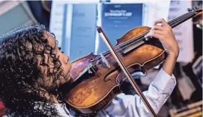  ??  ?? Caesar Sant practices with his violin at home in Memphis on June 25. Caesar was born with sickle cell anemia and at 5 years old experience­d three strokes that temporaril­y paralyzed him. BRAD VEST/THE COMMERCIAL APPEAL