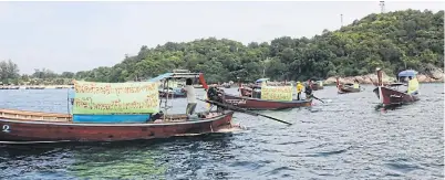  ?? PHOTO BY SATUN PUBLIC RELATIONS OFFICE ?? Sea gypsies travel in their boats along the shore of Koh Lipe on Dec 15. They have urged the government to solve a land dispute after a private firm closed off access from their village to the sea, a school, a hospital and a graveyard.