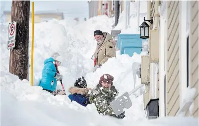  ?? ANDREW VAUGHAN THE CANADIAN PRESS ?? Residents shovel their sidewalk in St. John’s on Sunday as Environmen­t Canada warned 15 centimetre­s of snow was expected to fall between Sunday night and Monday morning.