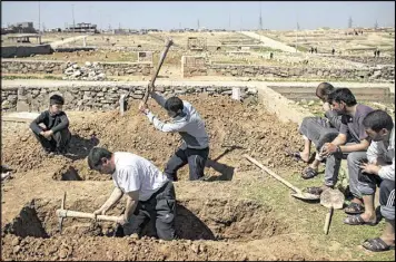  ?? FELIPE DANA / ASSOCIATED PRESS ?? Relatives and friends dig graves Saturday for two civilians killed in fighting between Iraqi security forces and Islamic State militants on the western side of Mosul, Iraq. U.S.led airstrikes flattened almost an entire block in the city.
