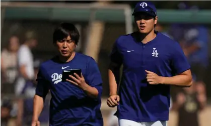  ?? ?? Shohei Ohtani, right, jogs on to a practice field with interprete­r Ippei Mizuhara during spring training. Photograph: Carolyn Kaster/AP