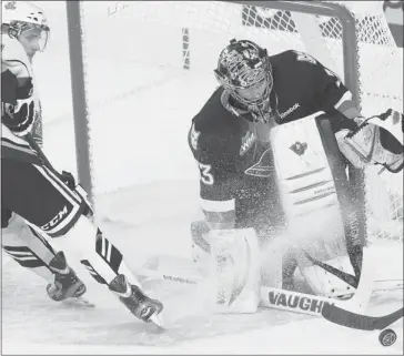  ?? Calgary Herald/files ?? Calgary Hitmen goalie Chris Driedger stops this scoring chance by during a game against the visiting Victoria Royals at the Scotiabank Saddledome in November. Calgary won the game 5-2.