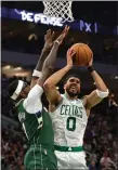  ?? GETTY IMAGES ?? Jayson Tatum goes up for a shot against Milwaukee’s Bobby Portis in the Celtics’ Game 6 win on Friday night.