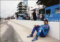  ?? Darron Cummings / Associated Press ?? Jimmie Johnson sits against the pit wall before practice for the Indianapol­is 500 on Sunday.