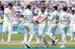  ?? —AFP ?? BIRMINGHAM: England’s Olly Stone celebrates with England’s captain Joe Root after taking the wicket of New Zealand’s Daryl Mitchell during play on the third day of the second Test cricket match between England and New Zealand at Edgbaston Cricket Ground yesterday.