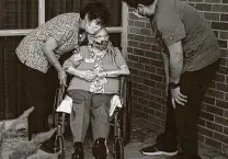  ?? Josie Norris / Staff Photograph­er ?? Betty Beck, center, gets a hug from home health caregiver Adriana Hernandez as Dion Muñiz, assisted living director, checks on her outside the Kaulbach Assisted Living community.