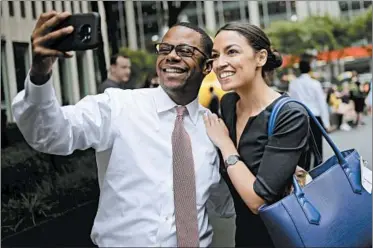  ?? SETH WENIG/AP ?? Rep.-elect Alexandria Ocasio-Cortez takes a selfie with a supporter in New York. Her posts are a hit with followers.