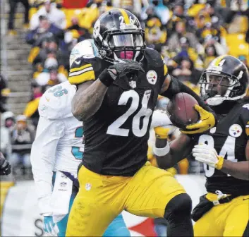  ?? DON WRIGHT/THE ASSOCIATED PRESS ?? Pittsburgh Steelers Le’Veon Bell sets a team postseason record with 167 rushing yards in a 30-12 AFC wild-card victory over the Miami Dolphins in Pittsburgh on Jan. 8.