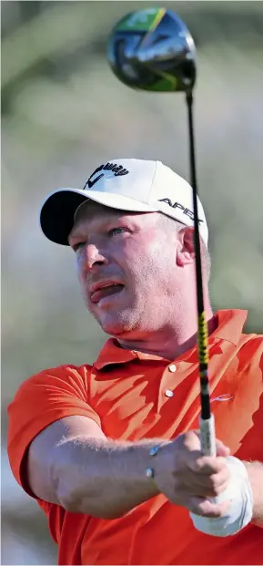  ?? AP ?? BRIGHT START: South Africa’s Shaun Norris follows his ball on the 18th tee during the first round of the Abu Dhabi Championsh­ip. —