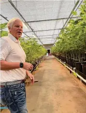  ?? Courtesy of CP090422we­edhemp ?? Brant Smith shows off his hemp farm in Cheshire. A state bill to allow hemp farmers to grow THC-laden cannabis is not likely to pass, legislator­s said.